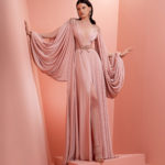 Long blush pink dress with  dramatic draped sleeves and fitted westline