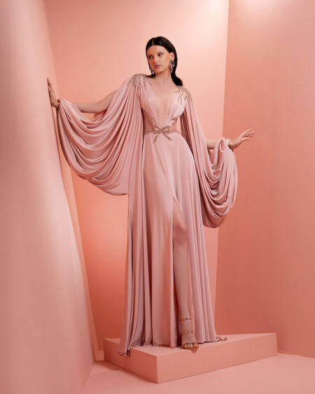 Long blush pink dress with  dramatic draped sleeves and fitted westline