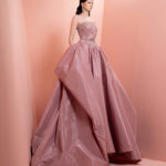 Strapless pink satin dress featuring a  fitted embellished bodice and a voluminous skirt
