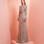 Fully beaded beige and light purple dress  with feathers on the cuff of the dress