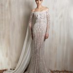 Ivory sheer fitted gown with off-shoulder lace detailing, delicate embellishments