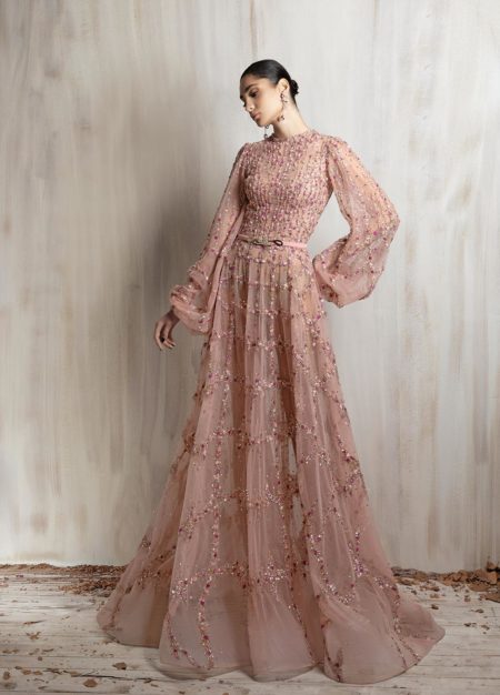 Blush pink beaded tulle gown with sheer long sleeves and flowing skirt