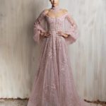 Soft blush pink beaded tulle gown with off-shoulder neckline and voluminous sleeves