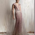 Rose gold beaded gown with deep V neckline and flowing sheer cape