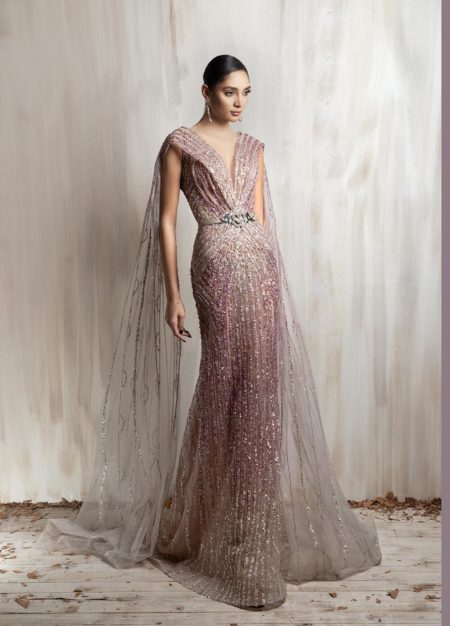 Rose gold beaded gown with deep V neckline and flowing sheer cape