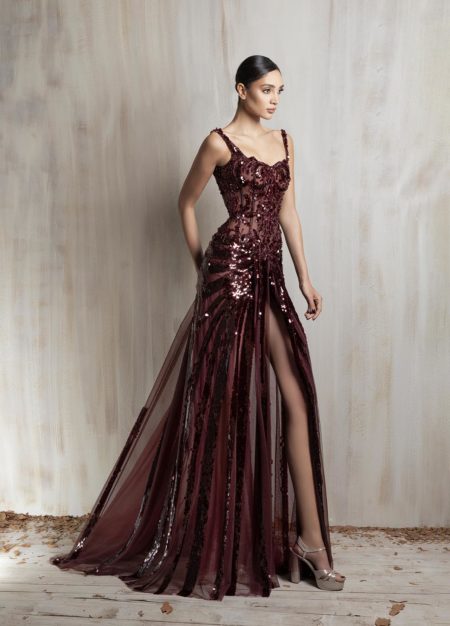 Burgundy sequined gown with sheer panels and high slit