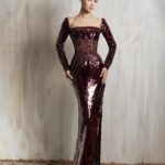 Burgundy sequined long-sleeve gown with sleek fitted silhouette