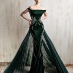 Off-shoulder deep emerald gown with a sculpted fitted silhouette