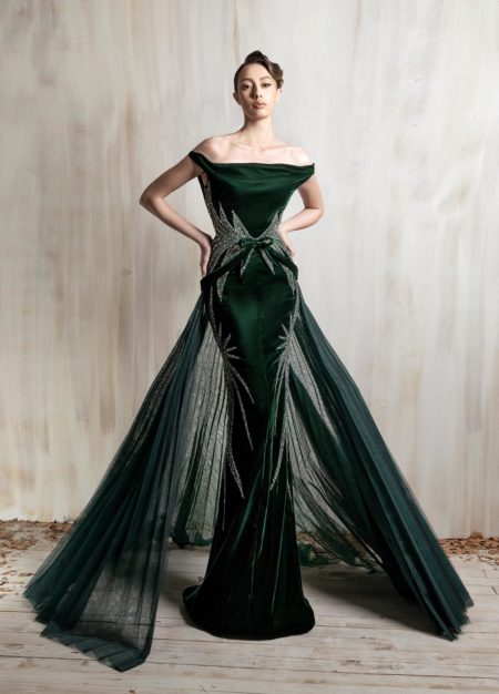 Off-shoulder deep emerald gown with a sculpted fitted silhouette