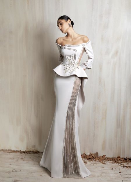 Off-shoulder off - white gown with a structured peplum bodice