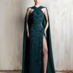 Emerald halter gown with beaded draping and a flowing cape.