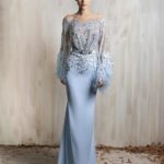 Blue gown with beaded illusion bodice and feathered sleeves.