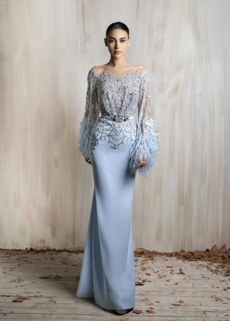 Blue gown with beaded illusion bodice and feathered sleeves.