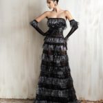 Black and silver strapless fringe gown with sheer gloves.