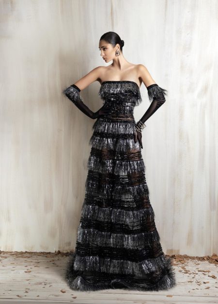 Black and silver strapless fringe gown with sheer gloves.