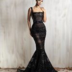 Black fitted mermaid gown with sheer beaded stripes.