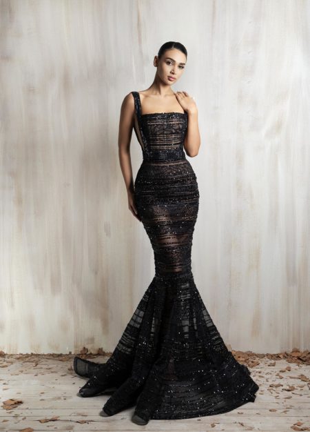 Black fitted mermaid gown with sheer beaded stripes.