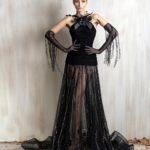 Black halter gown with floral neckline and sheer embellished skirt.