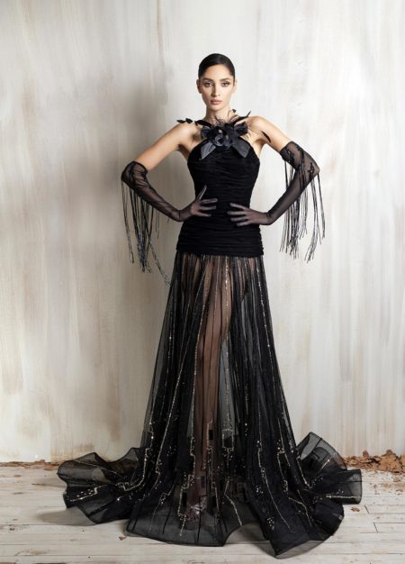 Black halter gown with floral neckline and sheer embellished skirt.