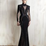 Black mermaid gown with sheer panels and embellished detailing.