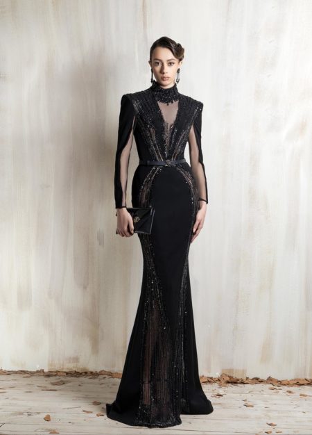 Black mermaid gown with sheer panels and embellished detailing.