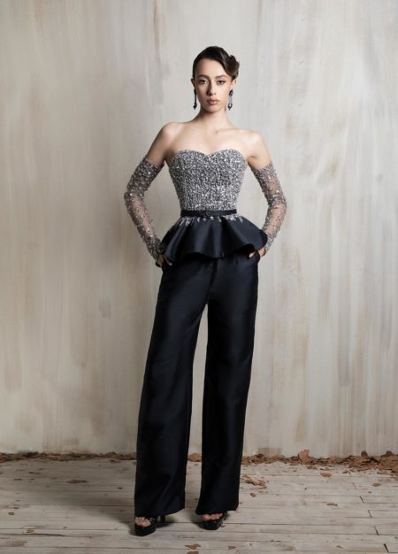 Crystal-embellished bodice with tailored black wide-leg trousers.