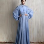 Powder blue gown with embroidered cape sleeves.