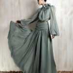 Flowing sage green chiffon gown with floral neckline detail.