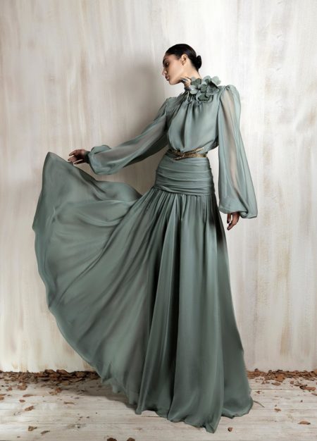 Flowing sage green chiffon gown with floral neckline detail.