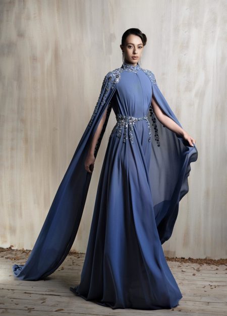 Royal blue cape gown with crystal-embellished cape.