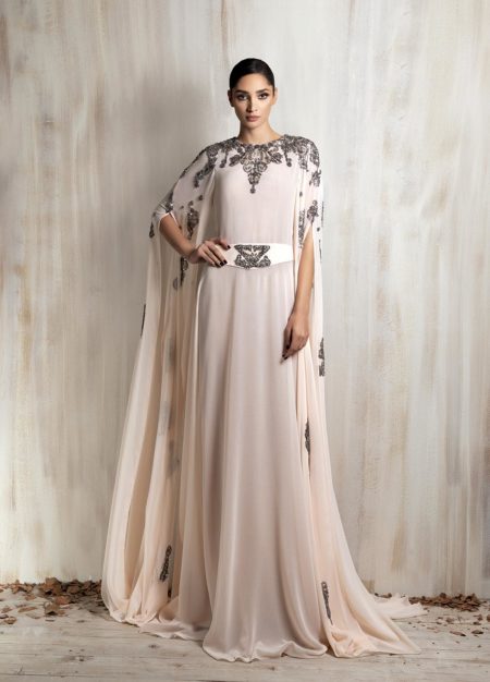 Soft blush cape gown with intricate silver embroidery.